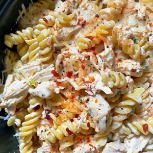 Crockpot Garlic Parmesan Chicken Pasta 1 Crockpot Garlic Parmesan Chicken Pasta served in a bowl with fresh herbs.