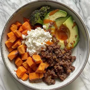 Hot Honey Beef Bowls Recipe 1 Hot Honey Beef Bowl topped with vegetables and drizzled in spicy honey sauce